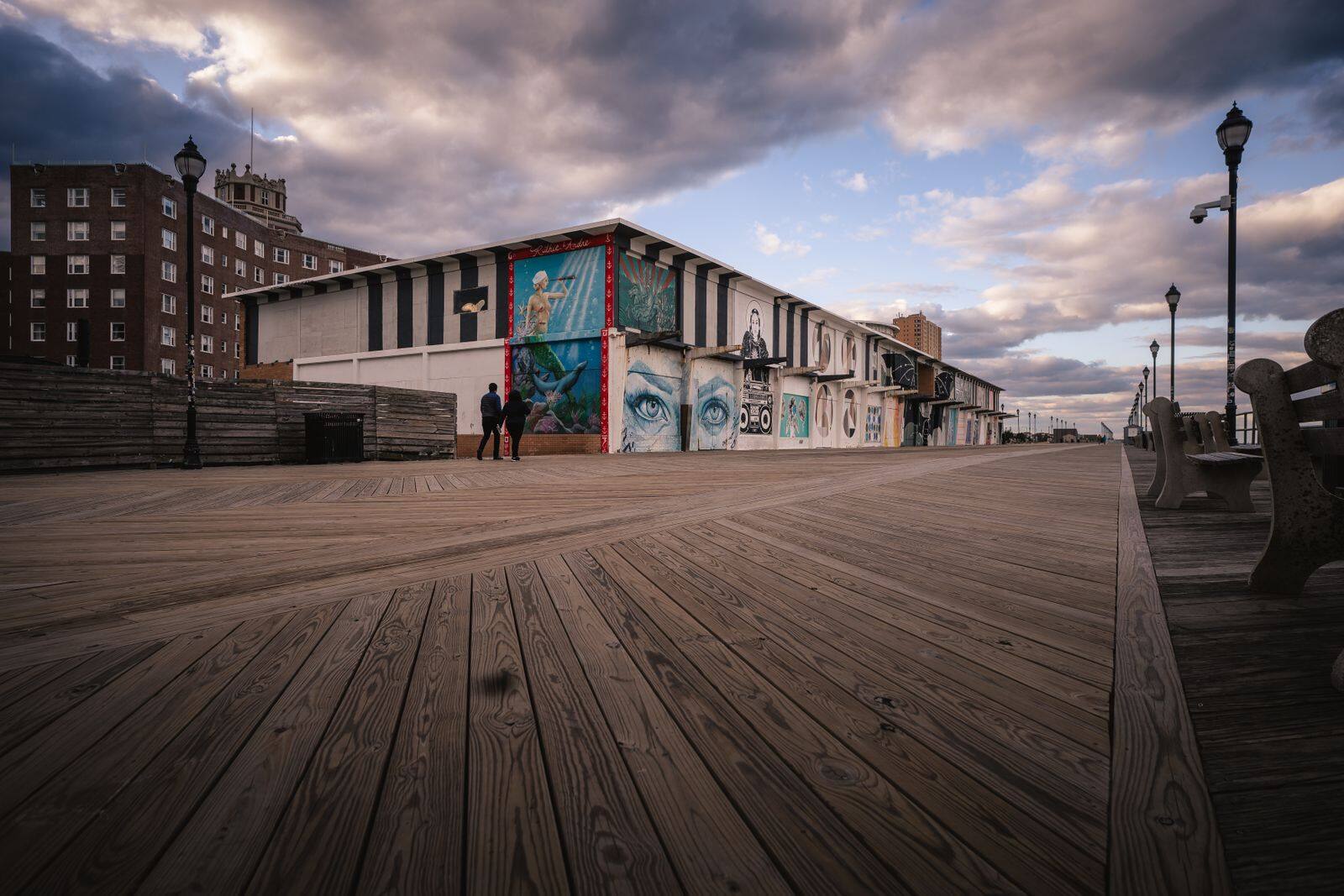 Murals along the Asbury Park boardwalk under a dramatic sky