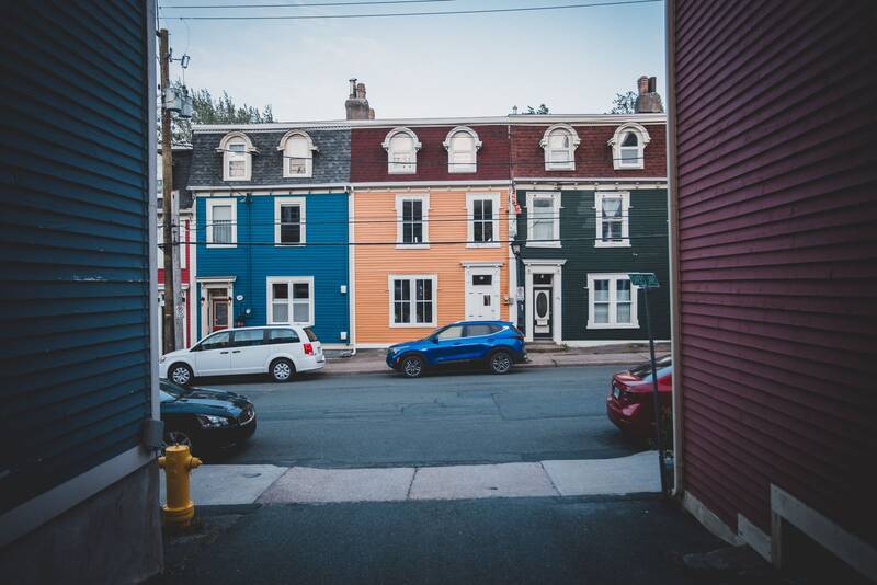 Colorful multifamily homes along a residential street, typical of Passaic County neighborhoods