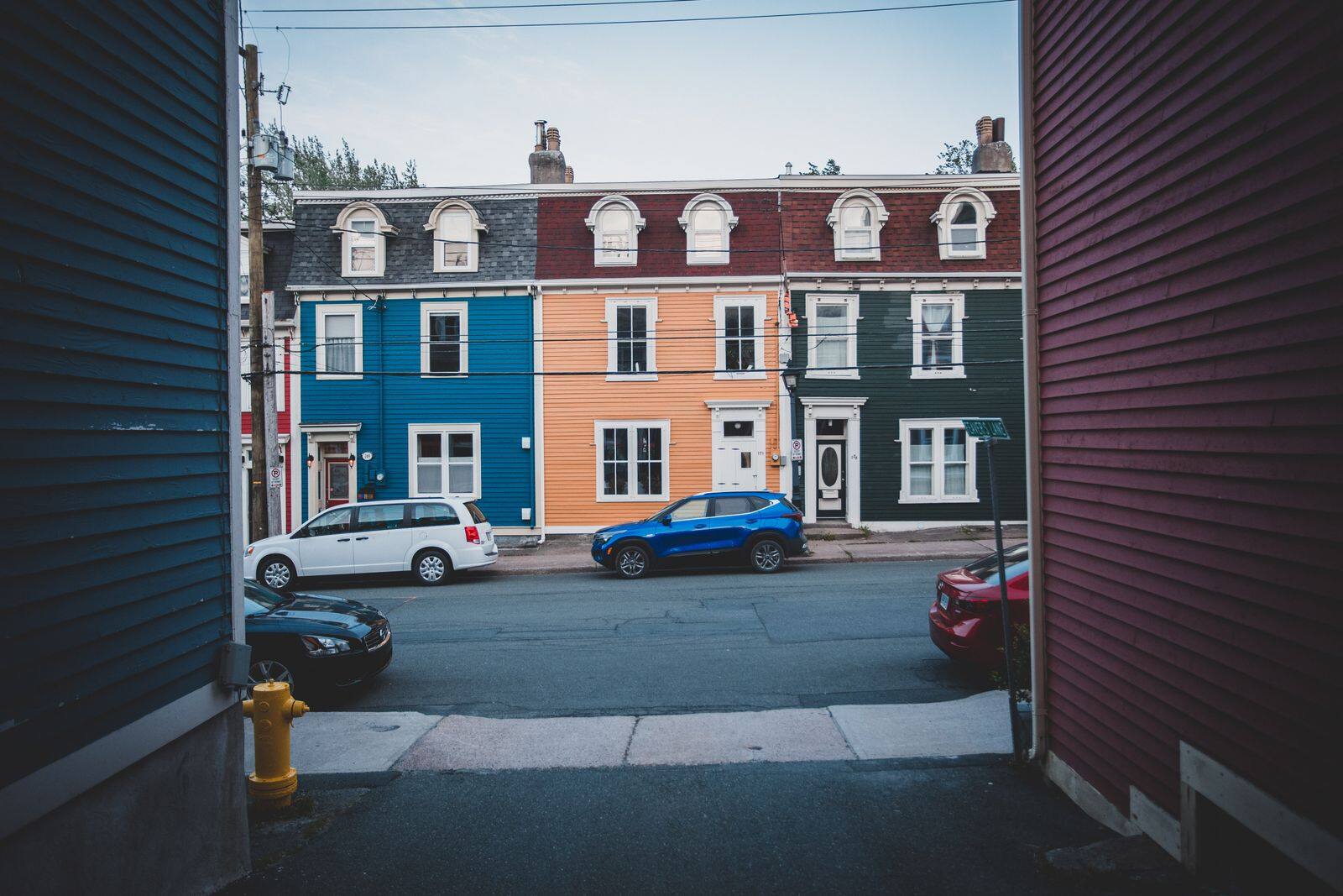 Colorful multifamily homes along a residential street, typical of Passaic County neighborhoods