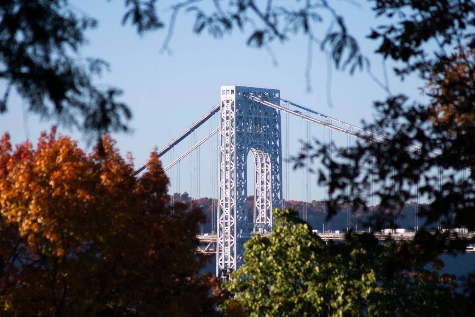 The George Washington Bridge framed by autumn leaves in Bergen County
