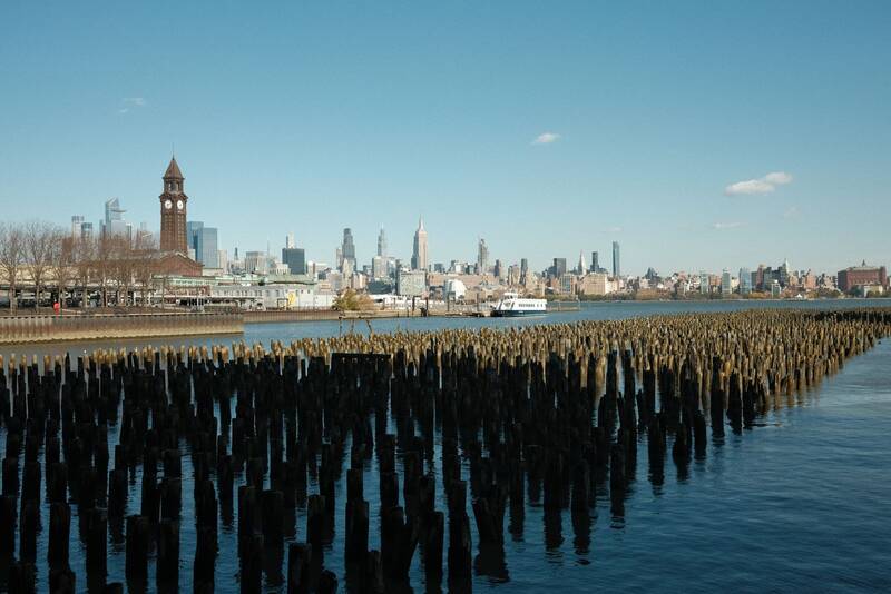 Old pier pilings along the Hoboken waterfront with the skyline behind