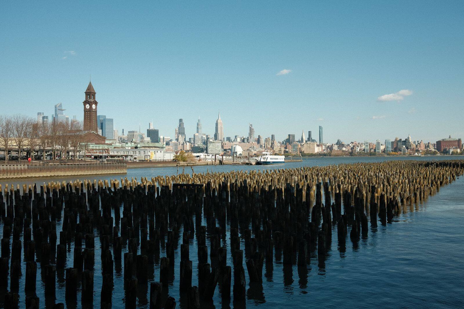 Old pier pilings along the Hoboken waterfront with the skyline behind