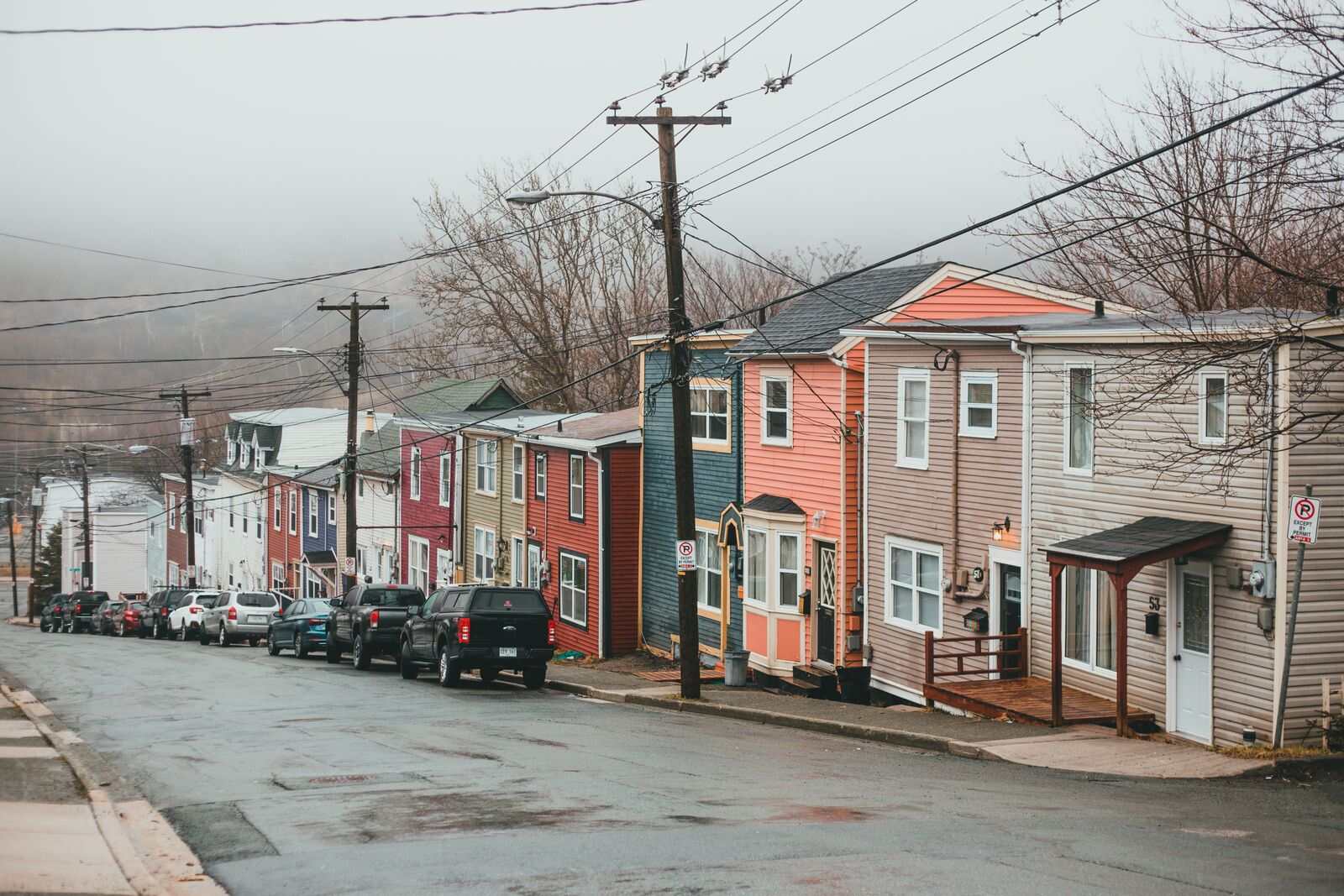 Rowhomes lining a hillside street on a foggy morning
